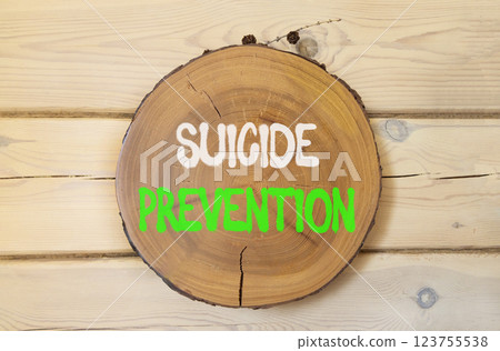 Suicide prevention symbol. Concept words Suicide prevention on beautiful wooden circle. Beautiful wooden wall background. Psychological and suicide prevention concept. Copy space. 123755538