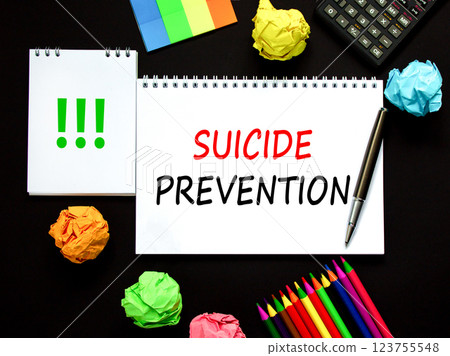 Suicide prevention symbol. Concept words Suicide prevention on beautiful white note. Black calculator. Colored pencils. Beautiful black background. Psychological suicide prevention concept. Copy space Suicide prevention symbol. Concept words Suicide prevention on beautiful white note. Black calculator. Colored pencils. Beautiful black background. Psychological suicide prevention concept. Copy space 123755548