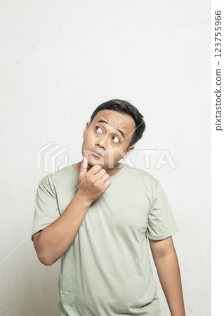 Funny looking man thinking wearing sage green shirt isolated on white. Funny looking man thinking wearing sage green shirt isolated on white. 123755966