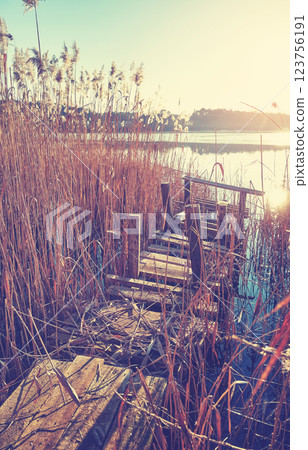 An old fishing platform on Barlinek Lake, color toning applied, Poland. An old fishing platform on Barlinek Lake, color toning applied, Poland. 123756191