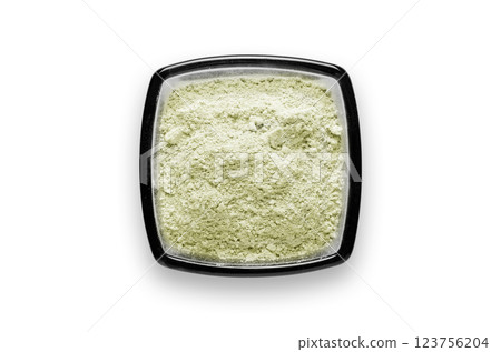 Cosmetic clay for a face mask in a bowl. Isolated on a white background. Cosmetic clay for a face mask in a bowl. Isolated on a white background. 123756204