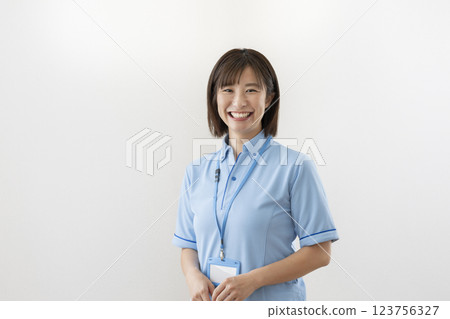 A facility staff member in his 30s smiling at the camera 123756327