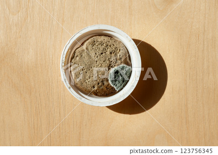 deteriorated meat pate with fungus and mold growth inside its packaging. Food safety, waste, and contamination concept deteriorated meat pate with fungus and mold growth inside its packaging. Food safety, waste, and contamination concept 123756345