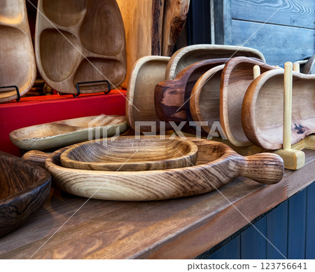 close-up of market stall showcasing variety of wooden kitchenware, including rustic bowls, plates, and serving boards, handmade craftsmanship and natural wood grains , eco-friendly kitchen decor close-up of market stall showcasing variety of wooden kitchenware, including rustic bowls, plates, and serving boards, handmade craftsmanship and natural wood grains , eco-friendly kitchen decor 123756641