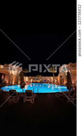 Night view of the hotel's illuminated swimming pool 123756812