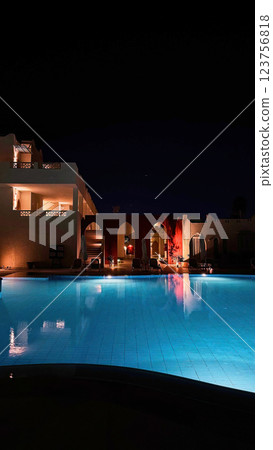 Night view of the hotel's illuminated swimming pool 123756818