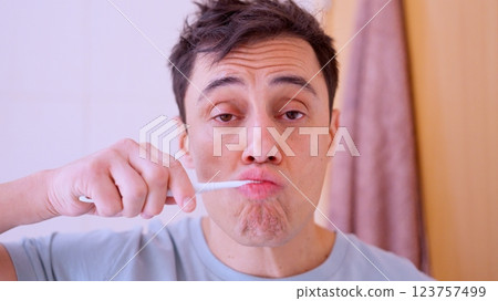 Man brushing teeth in bathroom mirror reflection montage Man brushing teeth in bathroom mirror reflection montage 123757499