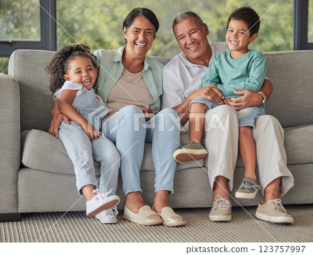 Grandparents, children and sofa happy in home living room on vacation or holiday together. Kids, grandma and grandpa in retirement smile on couch in lounge with love for family portrait in house 123757997
