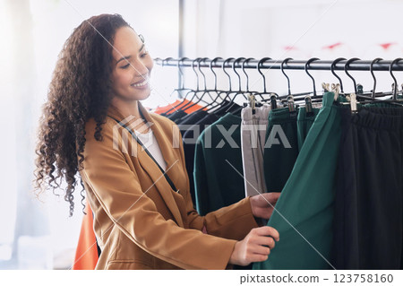 Retail, happy and woman with choice while shopping in a fashion boutique during a sale on clothes. Young black woman and customer withh smile in a store or shop for designer clothing on discount Retail, happy and woman with choice while shopping in a fashion boutique during a sale on clothes. Young black woman and customer withh smile in a store or shop for designer clothing on discount 123758160