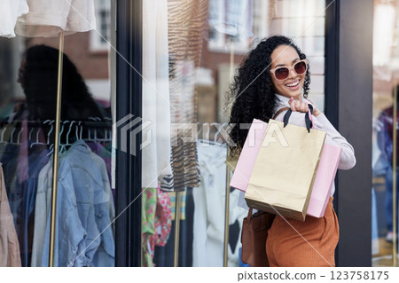 Fashion, happy and woman in the street shopping with a big smile enjoying sales deal and discount offers on retail stores. Customer with fancy clothes in shopping bags at an elegant luxury boutique Fashion, happy and woman in the street shopping with a big smile enjoying sales deal and discount offers on retail stores. Customer with fancy clothes in shopping bags at an elegant luxury boutique 123758175
