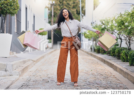 Woman customer, in street and with shopping bags celebrate sale from store, shopping and happy with purchase. Female consumer, confident client and excited outdoor, discount items and retail therapy. 123758178