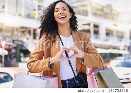 Heart, hands, shopping and woman with smile for retail, fashion and designer sale in the city of Miami. Portrait of a young girl in the street for a market, bags and love for store in the road 123758226