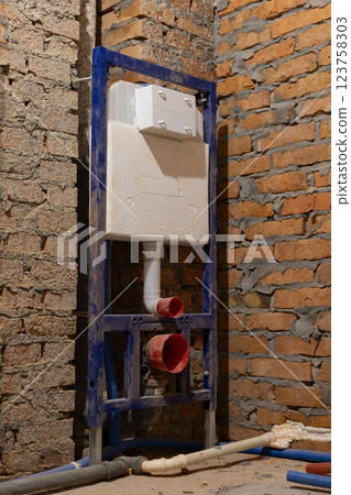 Install hung WC on a simple brick wall. Renovation concept. Install hung WC on a simple brick wall. Renovation concept. 123758303