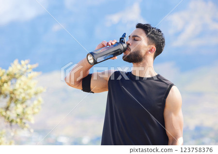 Fitness, blue sky and man drinking water from bottle to refresh and relax after workout, running or sports training. Cardio runner, exercise and thirsty young person with liquid drink for hydration 123758376