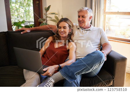 Movie, laptop and senior couple streaming a show on the internet on the living room sofa of their house. Happy, relax and elderly man and woman reading the news on the web with technology on couch 123758510