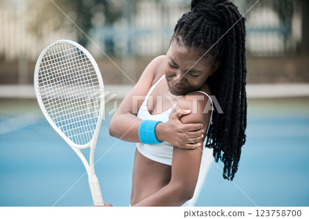 Muscle injury, tennis game and black woman with emergency health problem during competition, medical accident during sports and fitness training on court. African athlete with arm pain during cardio 123758700