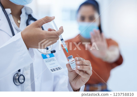 Doctor with covid vaccine, injection and corona medicine needle, bottle and syringe in hospital. Zoom in nurse hands, expert healthcare and flu risk, stop vaccination and reject medical treatment 123758810