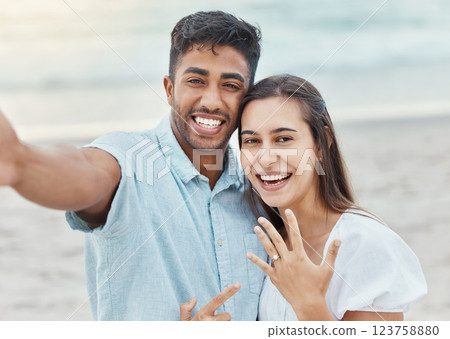 Couple selfie, engagement proposal or wedding ring at the beach, jewelry or engaged announcement. Romance face portrait, love and commitment of man and woman by the ocean celebrating with a smile. Couple selfie, engagement proposal or wedding ring at the beach, jewelry or engaged announcement. Romance face portrait, love and commitment of man and woman by the ocean celebrating with a smile. 123758880