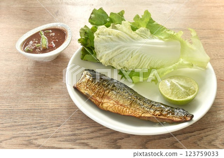 grilled Japanese saba mackerel fish and spicy shrimp chili paste sauce on plate eat couple with fresh vegetable 123759033