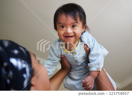 Happy, down syndrome baby and child mom care of a woman holding a kid with a disability at a house. Happiness and smile of a young toddler special needs face from India in a home with a mother 123759057