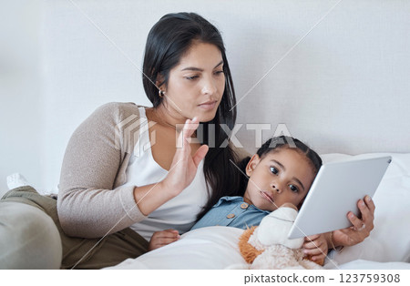 Mother and sick child, video call and with tablet for telehealth online consultation for daughter lying in bed. Serious woman and kid in bedroom greeting with 5g network communication for healthcare 123759308