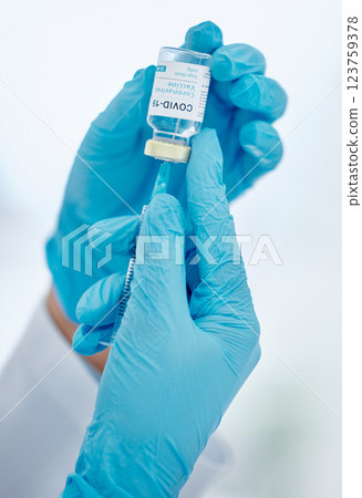 Covid vaccine, healthcare hands and needle for medical safety and protection against corona virus. Doctor with glass bottle liquid container for medicine research innovation, hospital or clinic help Covid vaccine, healthcare hands and needle for medical safety and protection against corona virus. Doctor with glass bottle liquid container for medicine research innovation, hospital or clinic help 123759378