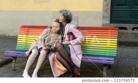 Grandmother with granddaughter on LGBT-colored bench 123759573