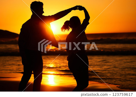 Sunset, dance and silhouette of couple by the beach together for love, travel and Puerto Rico holiday. Summer, sunrise and nature with man and woman dancing by the sea for vacation, happy and relax 123759617