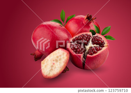 Ripe pomegranate fruit isolated on a red background 123759710