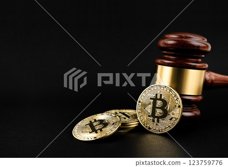 Bitcoin cryptocurrency  with wooden hammer or judge gavel on black background. 123759776