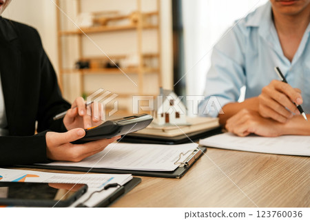 Businesswoman embraces client after successful property negotiation. 123760036