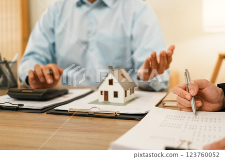 Businesswoman embraces client after successful property negotiation. 123760052