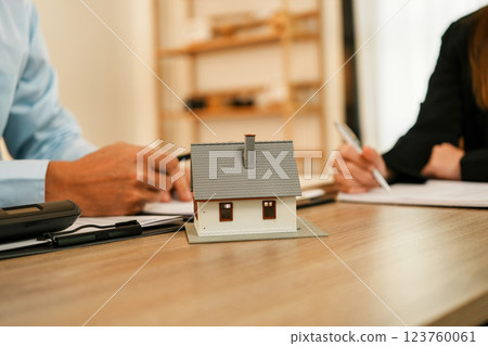 Businesswoman embraces client after successful property negotiation. 123760061