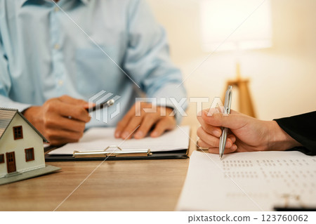 Businesswoman embraces client after successful property negotiation. 123760062