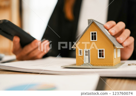 Businesswoman embraces client after successful property negotiation. Businesswoman embraces client after successful property negotiation. 123760074