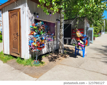 There is a small souvenir shop with colorful helium balloons in the park. There is a small souvenir shop with colorful helium balloons in the park. 123760127
