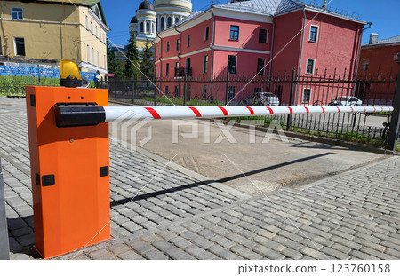 Rybinsk Russia 06 24 2024 Orange automatic barrier on a clear summer day. 123760158