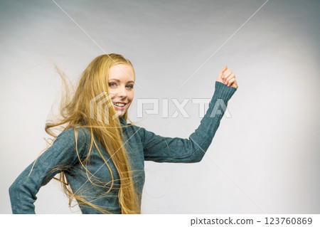 Smiling woman with blowing long hair 123760869
