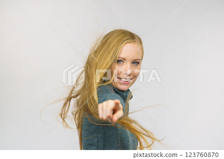 Female with blowing hair point at you Female with blowing hair point at you 123760870