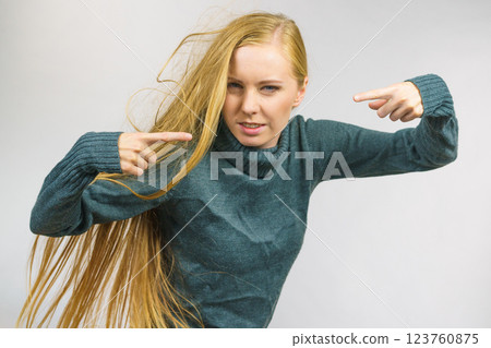 Angry female pointing with fingers 123760875