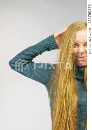 Displeased girl with messy long hair 123760876