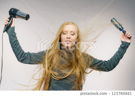 Girl holds hair accessories, styling hair 123760881
