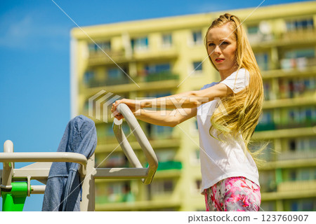 Female doing exercise in outdoor gym 123760907
