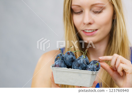 Girl holds plum fruits 123760940