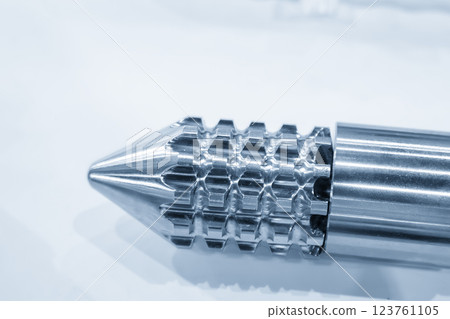 Close up scene the head of barrel screw of injection machine spare parts in the light blue scene. 123761105