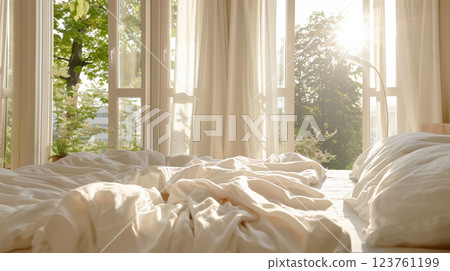 A bright and airy bedroom with freshly made bed, clean sheets, and open windows letting in sunlight and fresh air, symbolizing the renewal energy of spring cleaning. 123761199