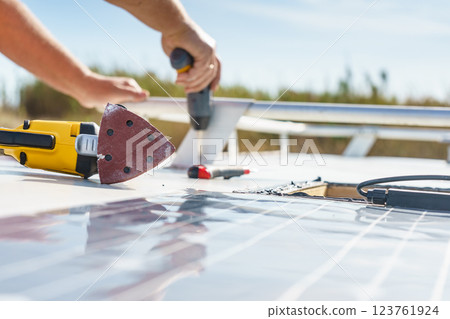 RV solar panel installation. Caravan roof repair 123761924