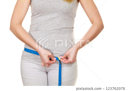 Woman measuring her hips closeup 123762078