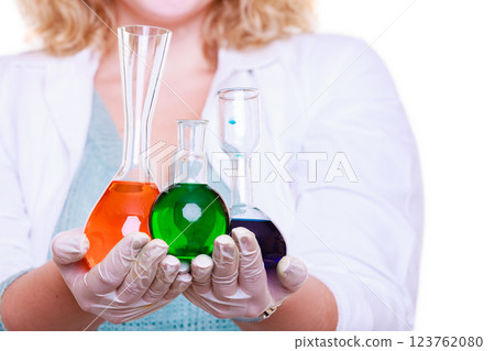 Chemist woman holds test flask 123762080