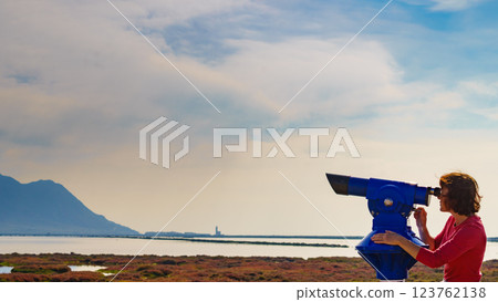 Woman using tourist binoculars, Cabo de Gata, Spain 123762138